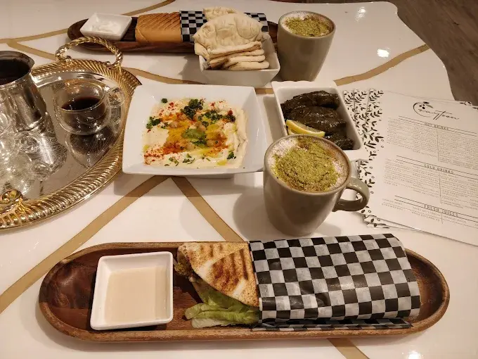 Zaytoon Restaurant & Cafe interior in Osborne Village Winnipeg — greenery-filled Middle Eastern dining atmosphere